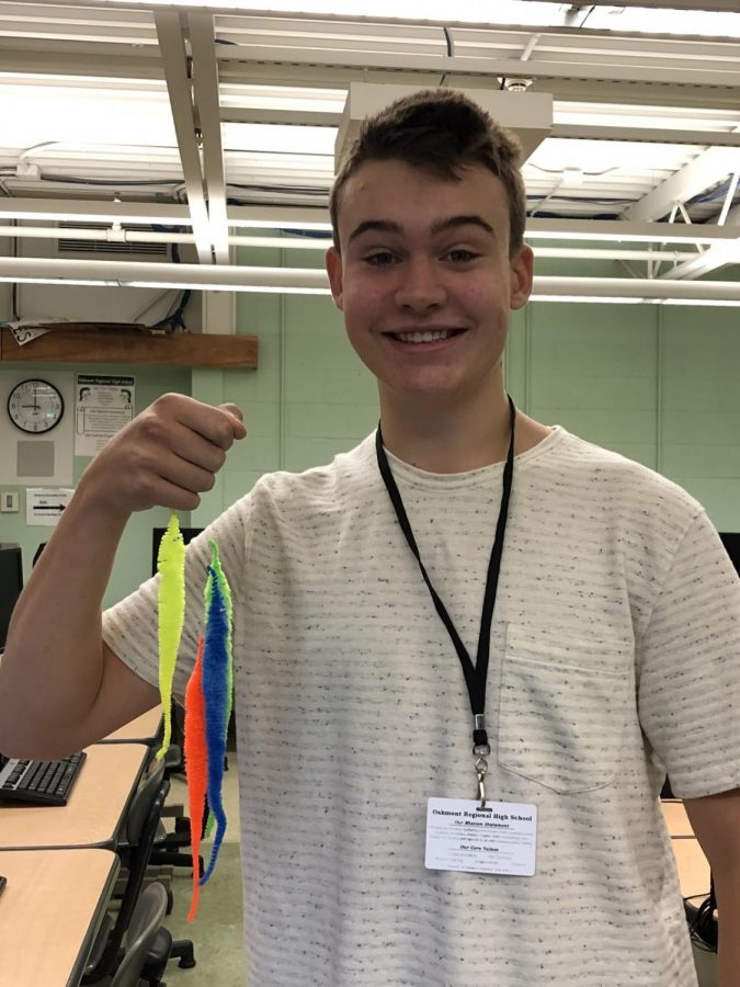 Branden Hoegen, “worm connoisseur,” is shown holding worms Cornhusk, Ronald Reagan, Bartholomew, and Horton