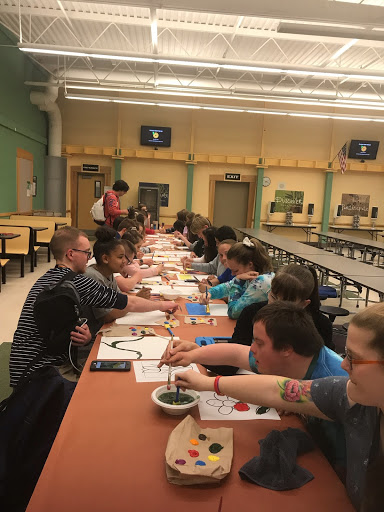 Members of Friends Club having fun at a painting event put on by the club. 