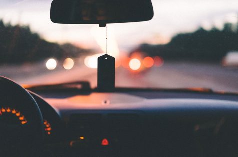 Dashboard, steering wheel, and air freshener in car on a highway in Moskovskaya Kovaltseva Avtomobilnaya Doroga. Original public domain image from Wikimedia Commons