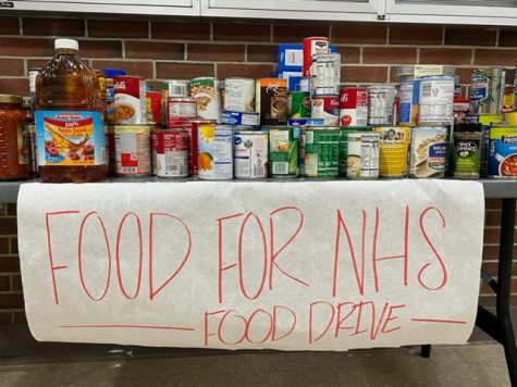 Located next to the cafeteria, the table for the food drive is already getting filled!
