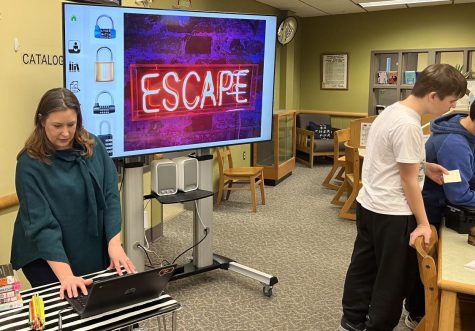 Mrs. Morin leads Mrs. Staffords class in library escape room activity. 