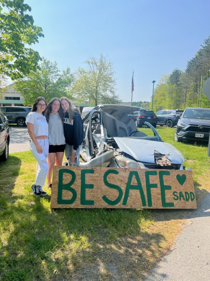 SADD E Board members Madi Reed and Jada Sibley flank SADD member and artist Ava Cote who painted the BE SAFE placard for Prom Safety Awareness
