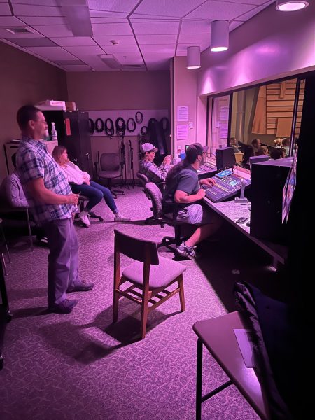 Ryan Mayne, Brenton Maddux work lights and sound at NHS induction. 