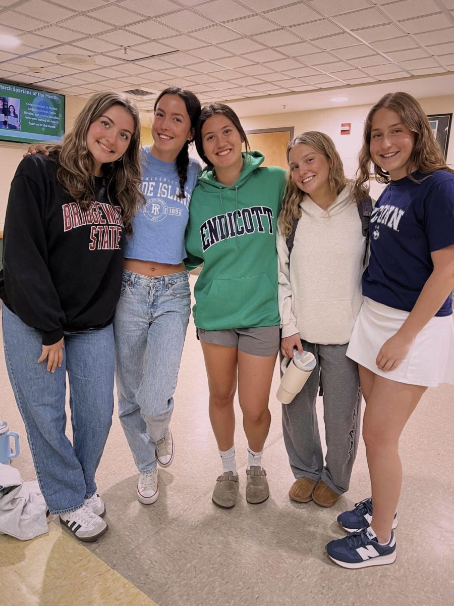 Bella Rios, Ella Dellasanta, Kenzie Correa, Ava Franciosi, and Ava Cote wearing their college merchandise on decision day.