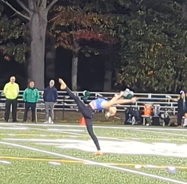 Ellarie Healey baton twirls at Field hockey senior night.