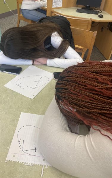 Leah Fithian and Nadalee Madhere caught napping in the library after a rough night's sleep.