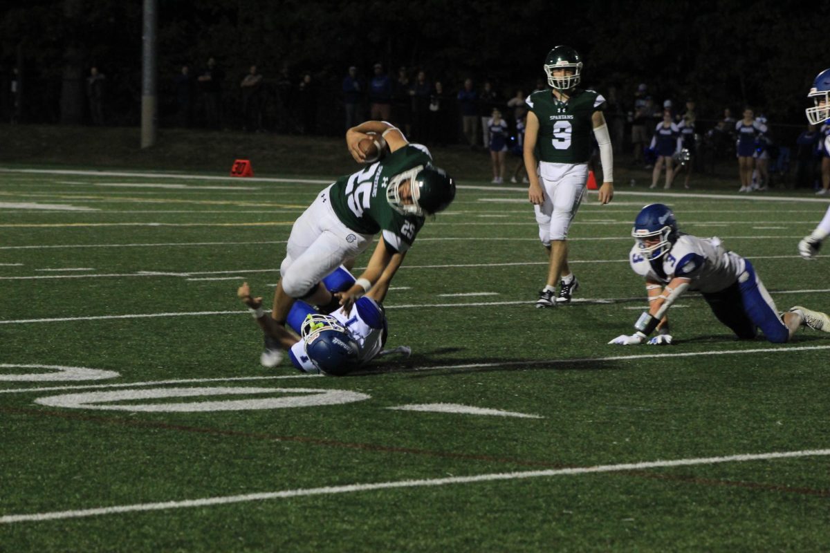 Spartan Darious Legere, powers through the defense.