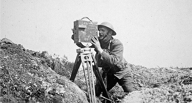 Lt. Edwin Cooper operating movie camera in front line trenches, July 1918

