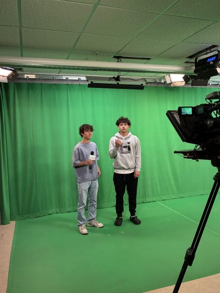 Oakmont Senior, Josh LeGrand, asking Sophomore, Isaiah Rocca, about his article in the OTV studio.