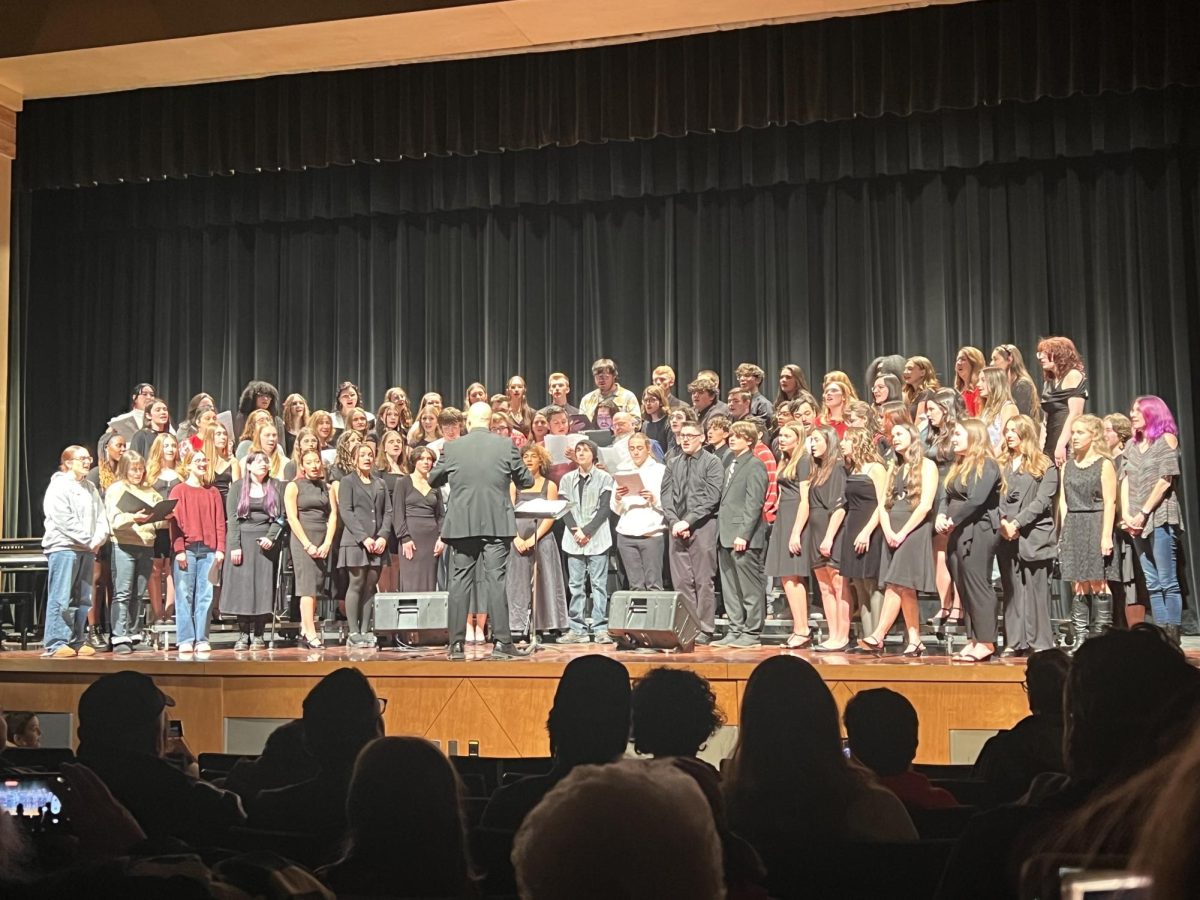 Oakmont choir members are joined by alumni members to spread holiday cheer