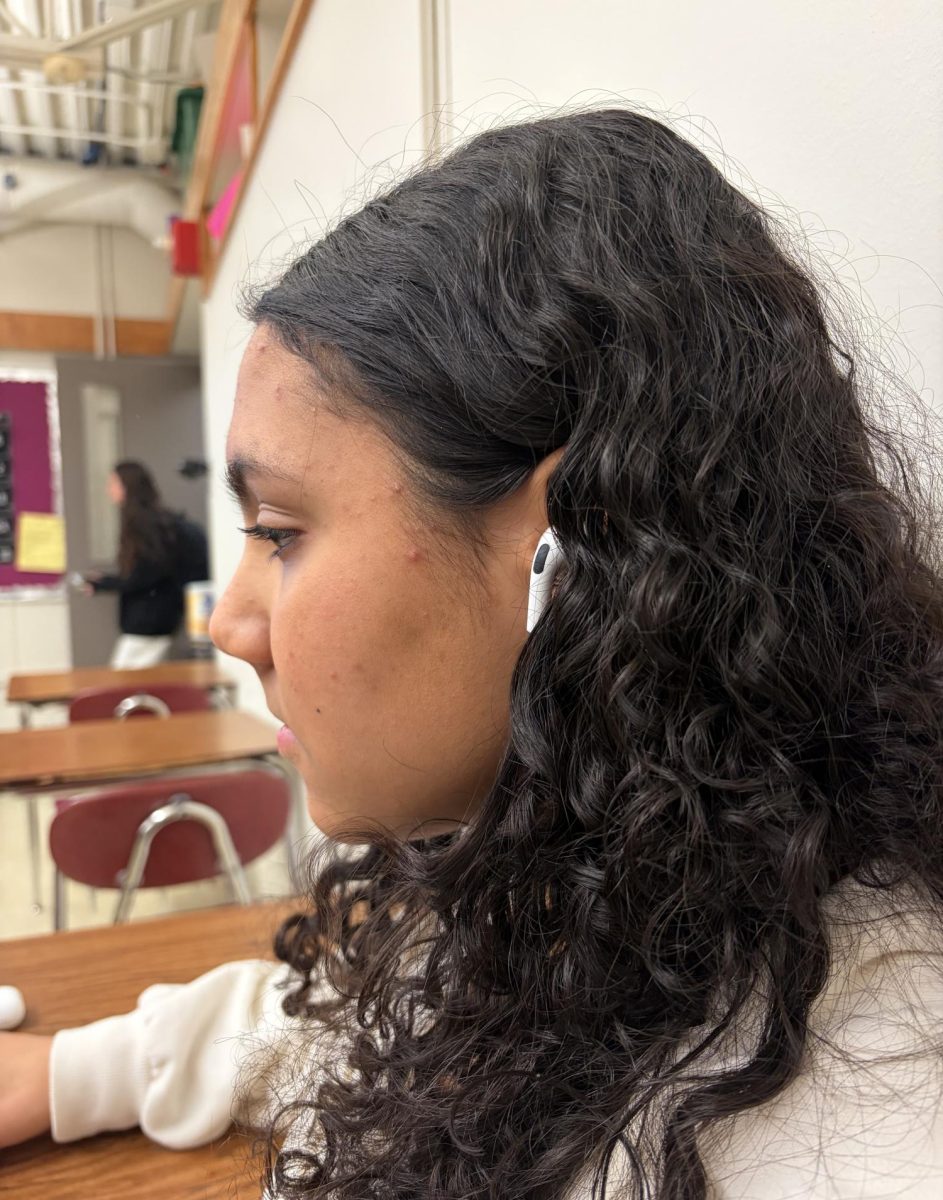 Abigail Suarez, a student at Oakmont Regional High, listening to music while studying