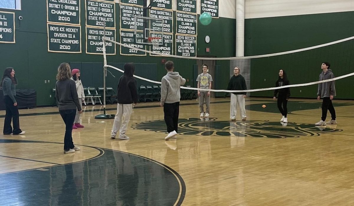 Students playing big ball volleyball in Ms, Roy class in the new gym