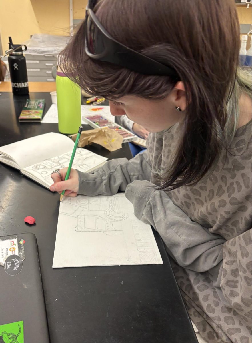 Senior Cassidy Boyce continuing the beginning sketches of her piece.