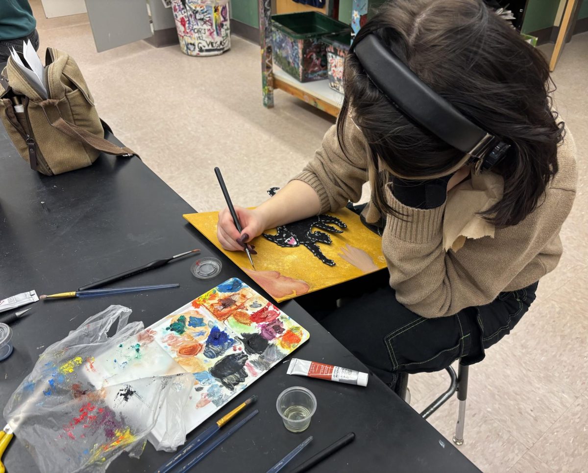 Senior Viktor Stasiak applying pristine details on his painting.