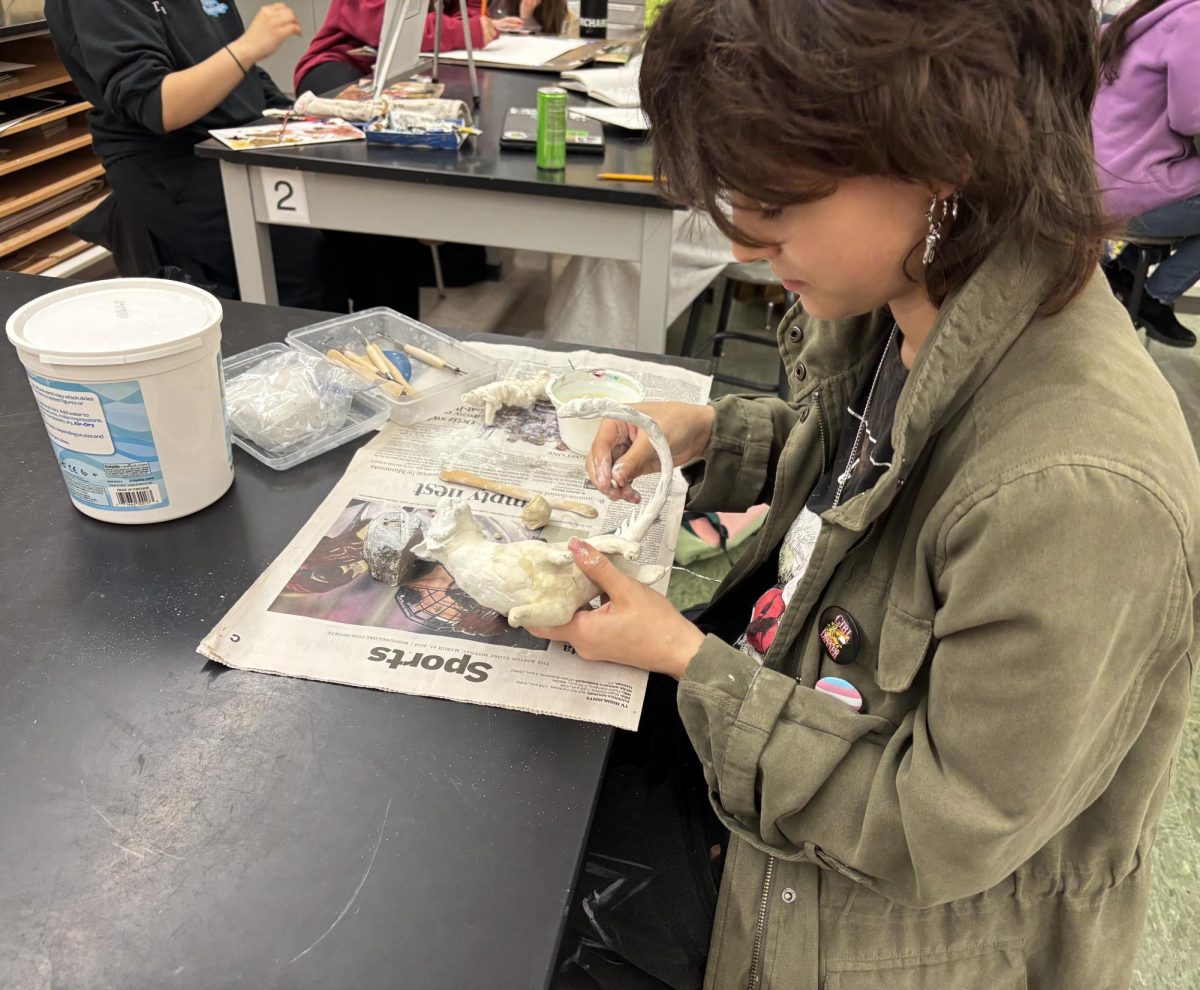 Senior Cassidy Bowler sculpting the beginning phases of  their dragon.
 