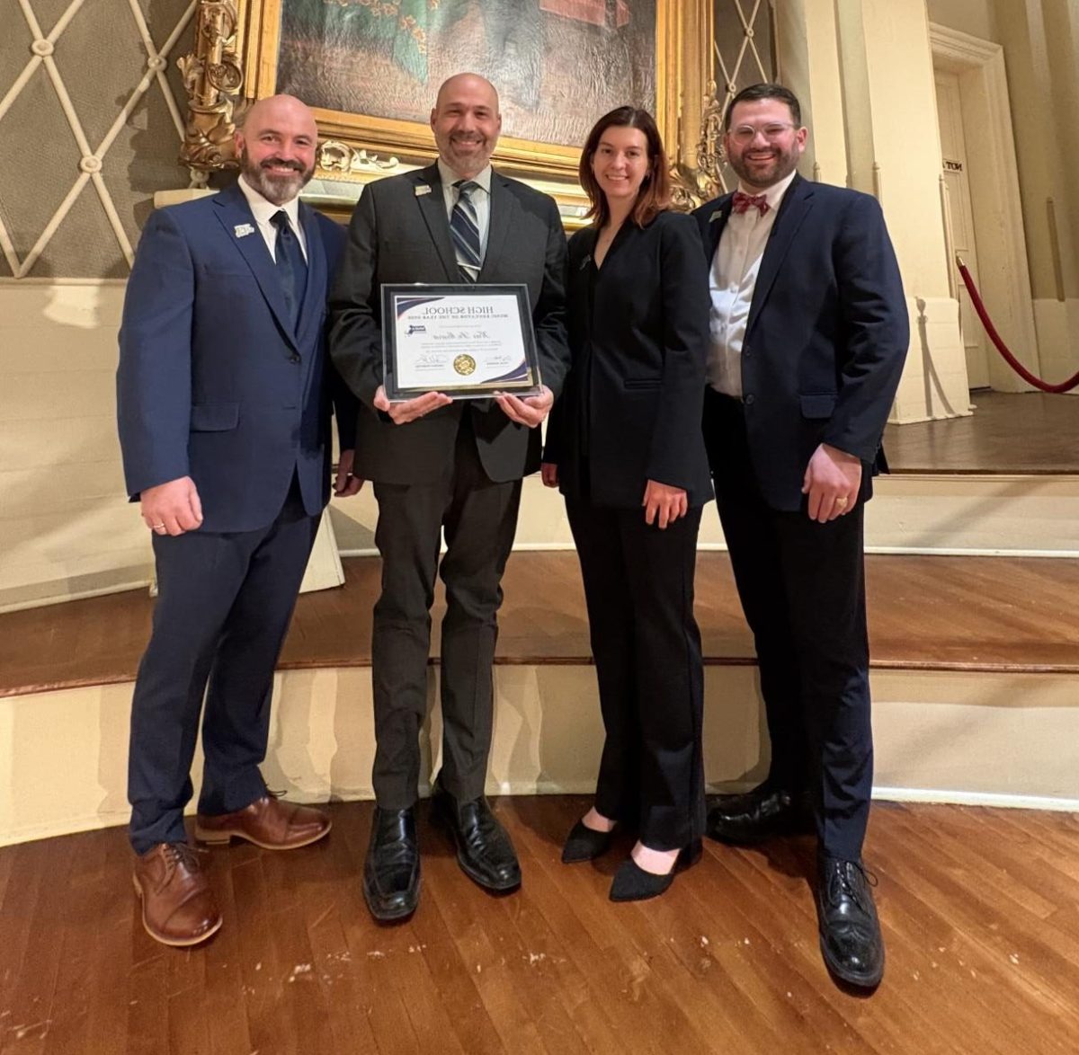 DeMoura holds CDMMEA High School Music Educator of the Year Award. 