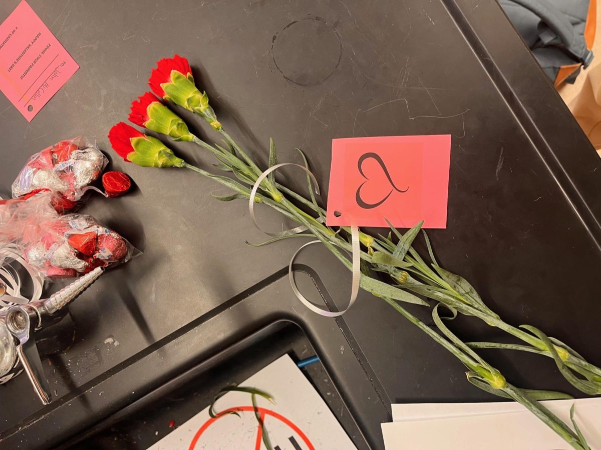 The flowers and candies are then tied together.
