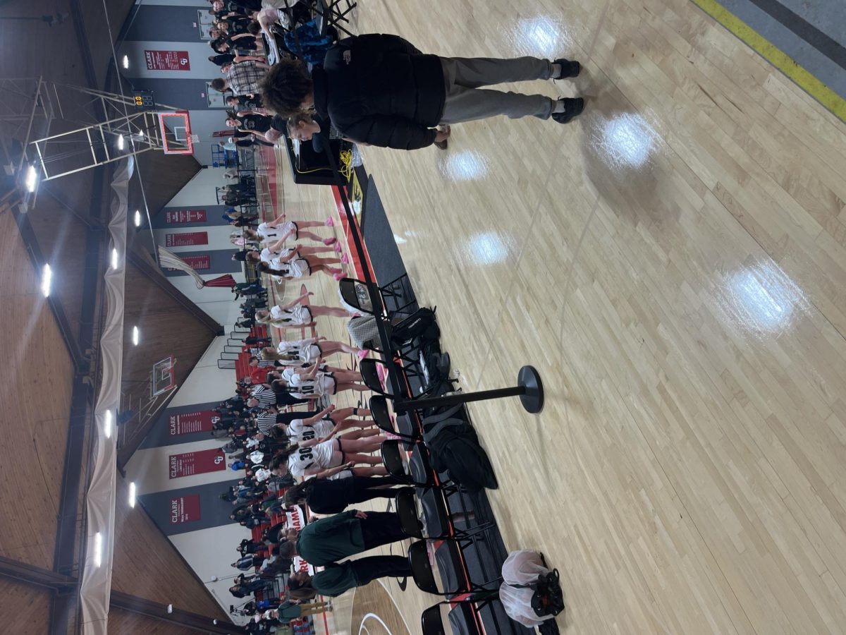 Girls shake hands with Grafton after the game.