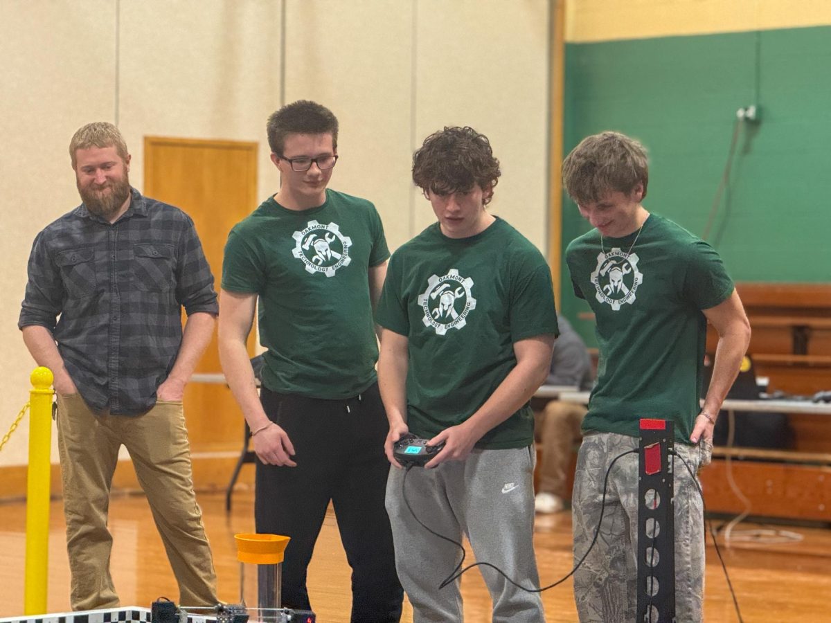 Members of the Oakmont Regional High School robotics team operate their robot during the teleoperated period of a match.