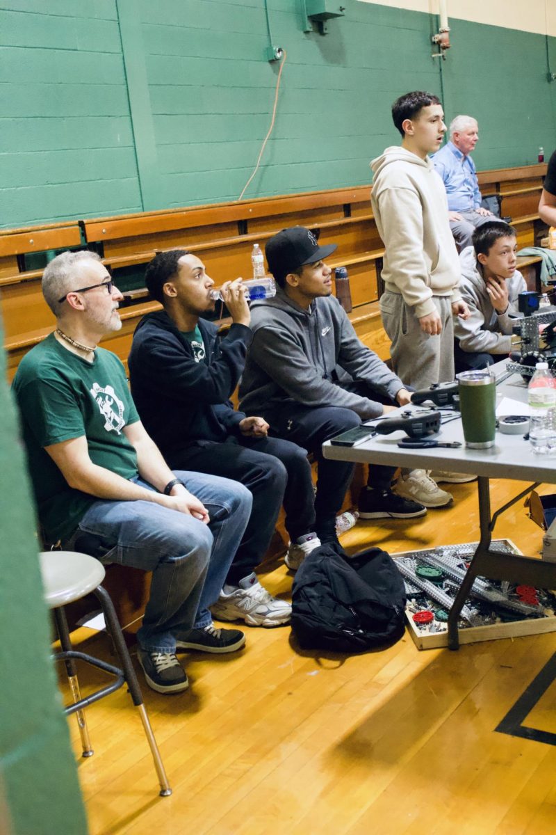 Members of the Oakmont Regional High School robotics club observe the ongoing matches