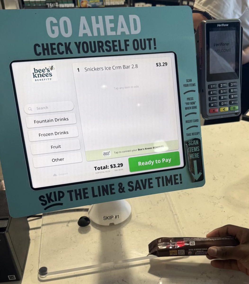 Oakmont student Kunashe Kurapa using the self checkout 