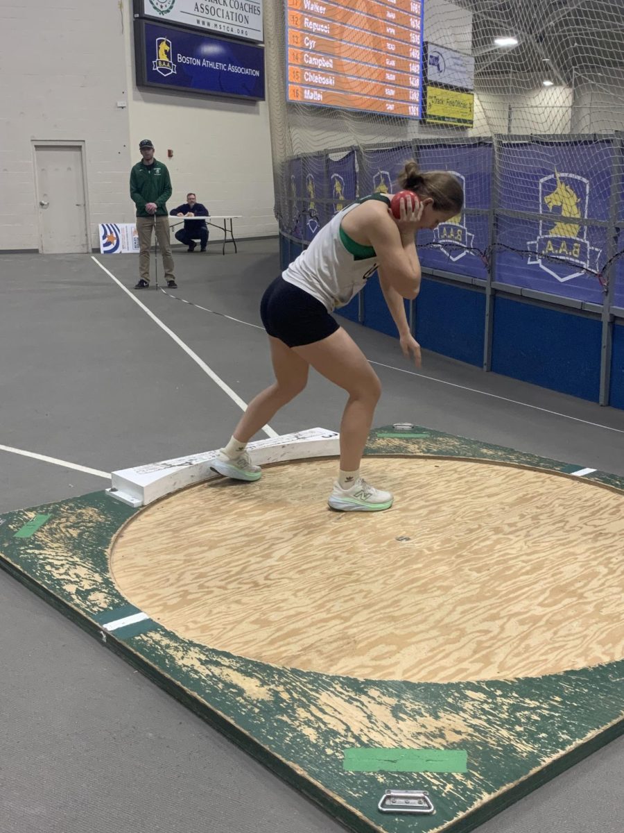 Mikaela G throwing shot put. 