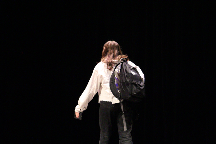 Group member with a backpack during her March Madness performance. 