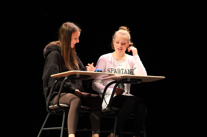 Two students playing a game show for their March Madness performance.