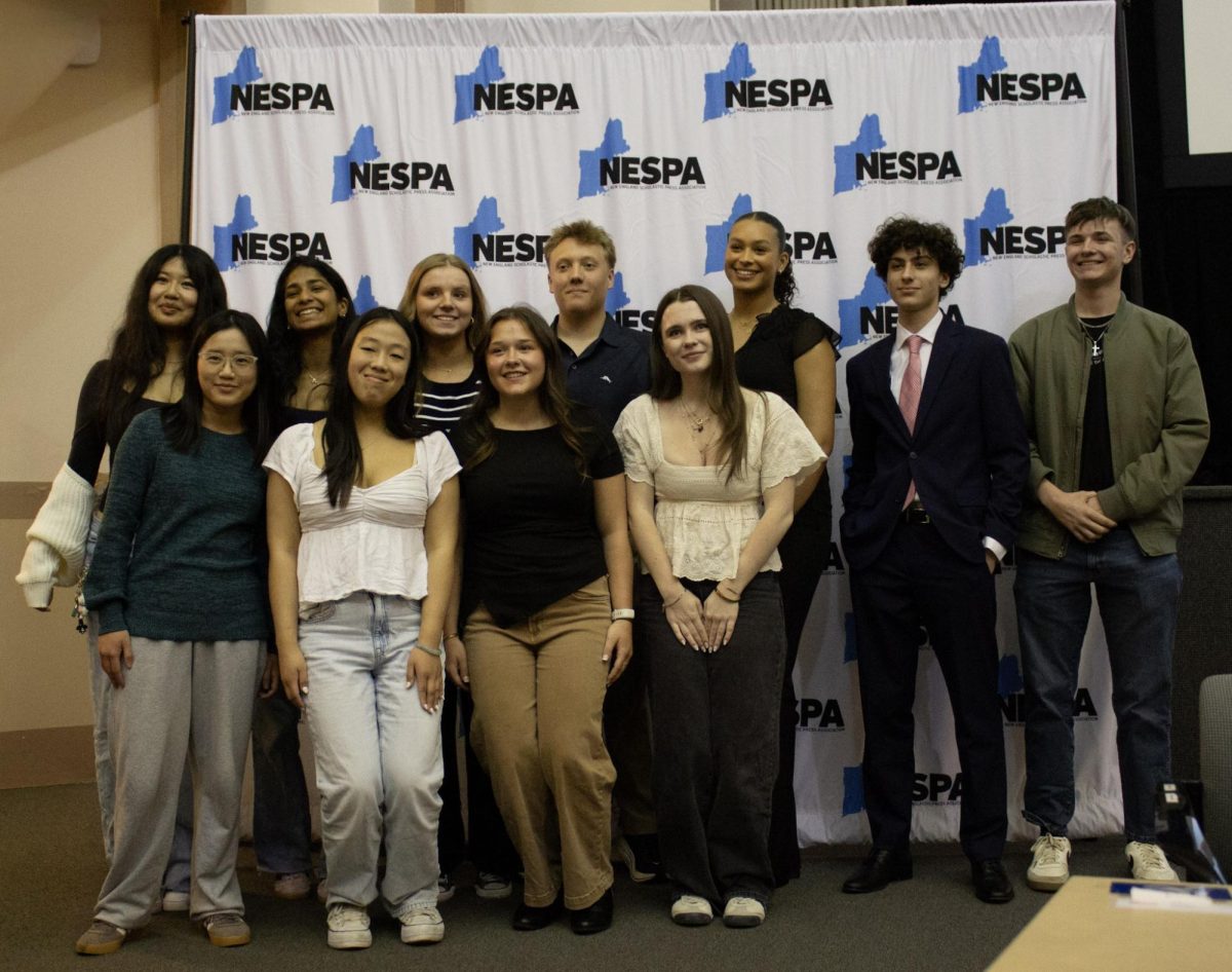 All New England staff posing for picture before receiving awards.