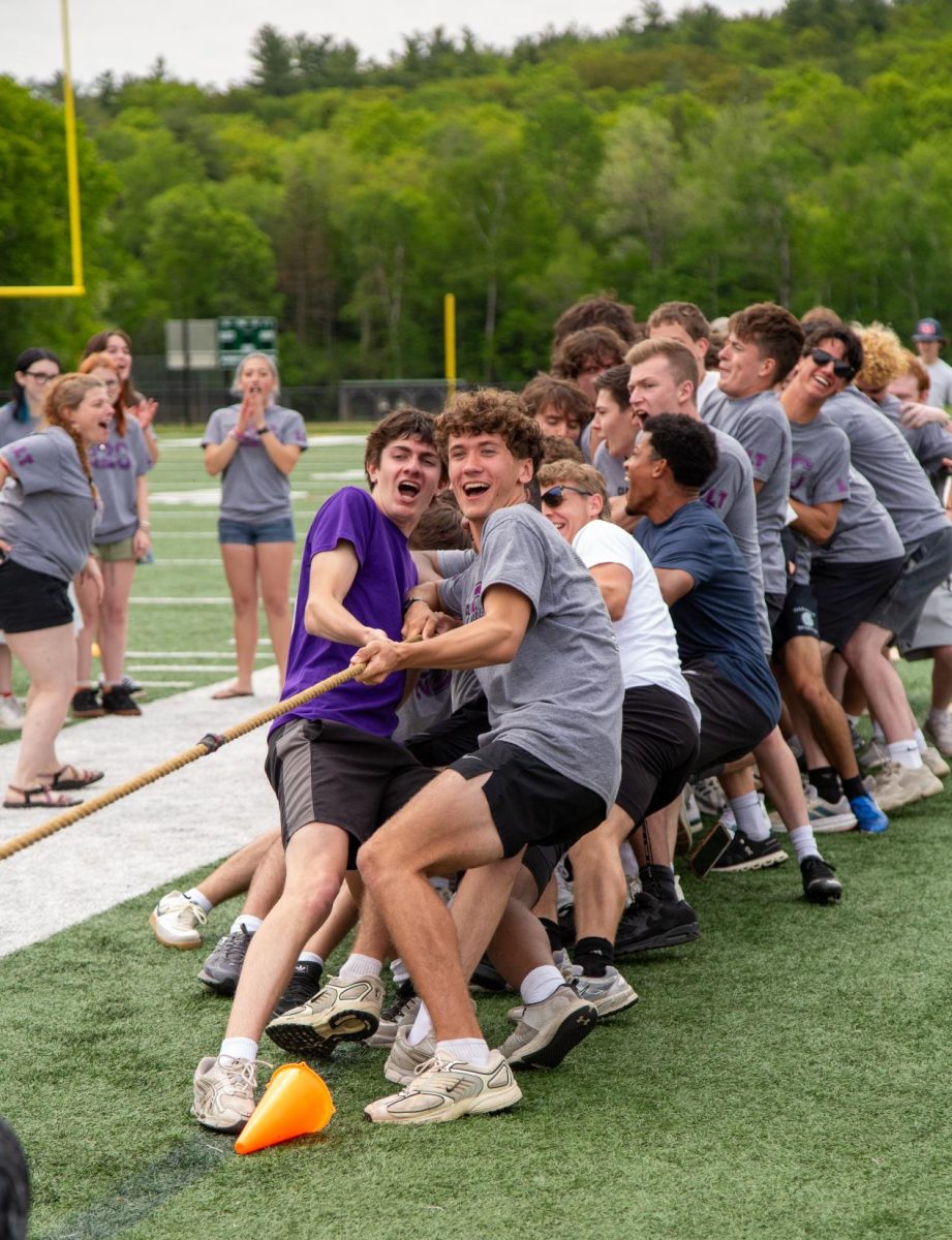 Senior boys competing in tug-of-war against junior boys.