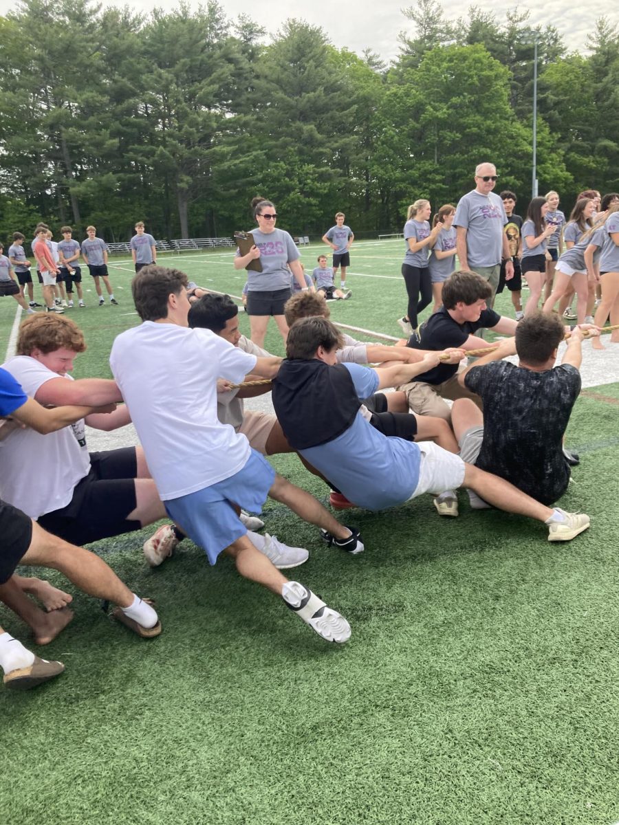 Juniors playing tug a war and using a lot of strength.