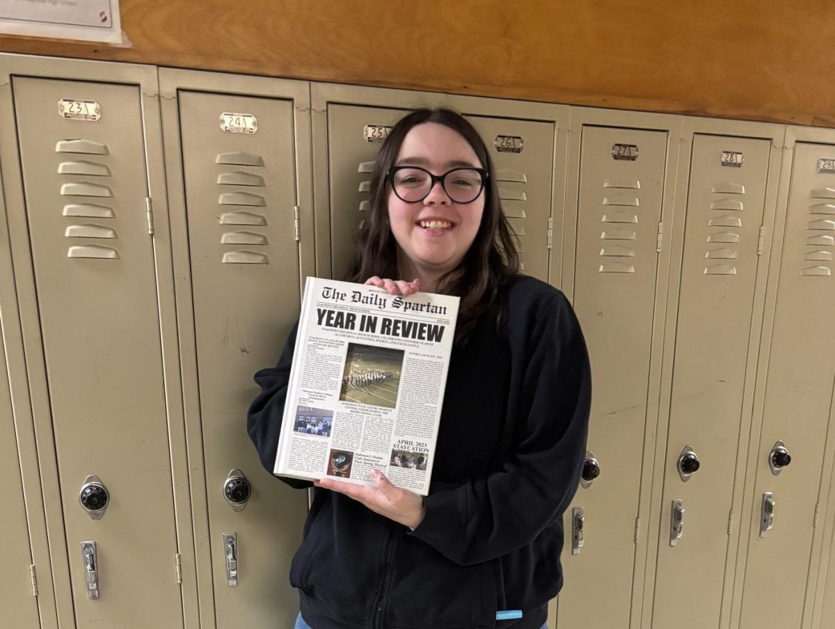 Kelly Sandman showing off her new yearbook as they are being given out by Mr. Dufour!