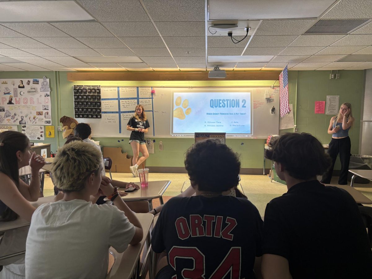 Juniors Katarina Pelkey, Chloe Kruse, Madeleine Habel, and Lauren Bagley leading their experiment on Oakmont trivia with lower and upperclassmen.