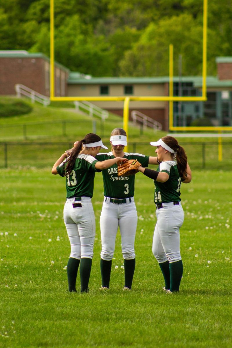 Outfielders coming together before the inning starts.
