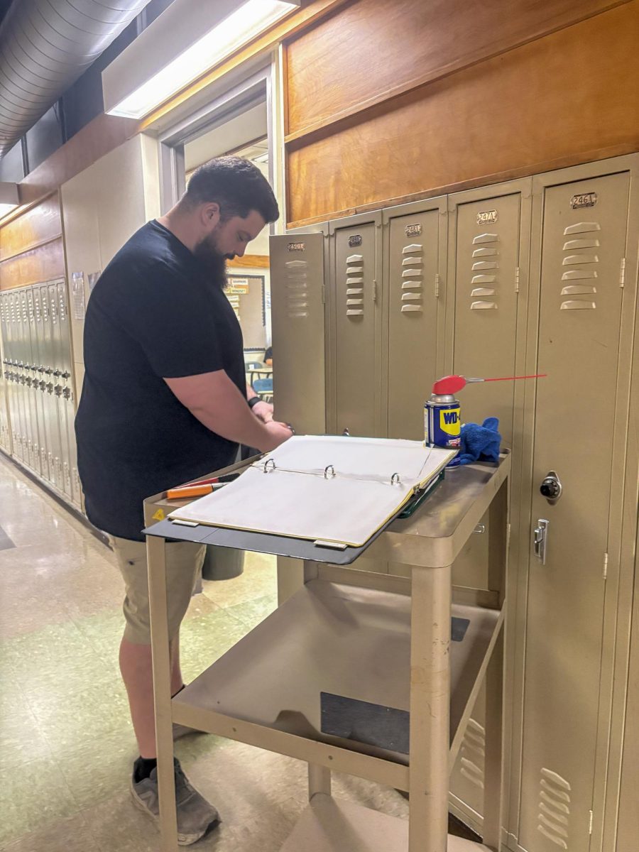 Head custodian, Dave Wiita begins to clean out all lockers for next year's phone ban. 