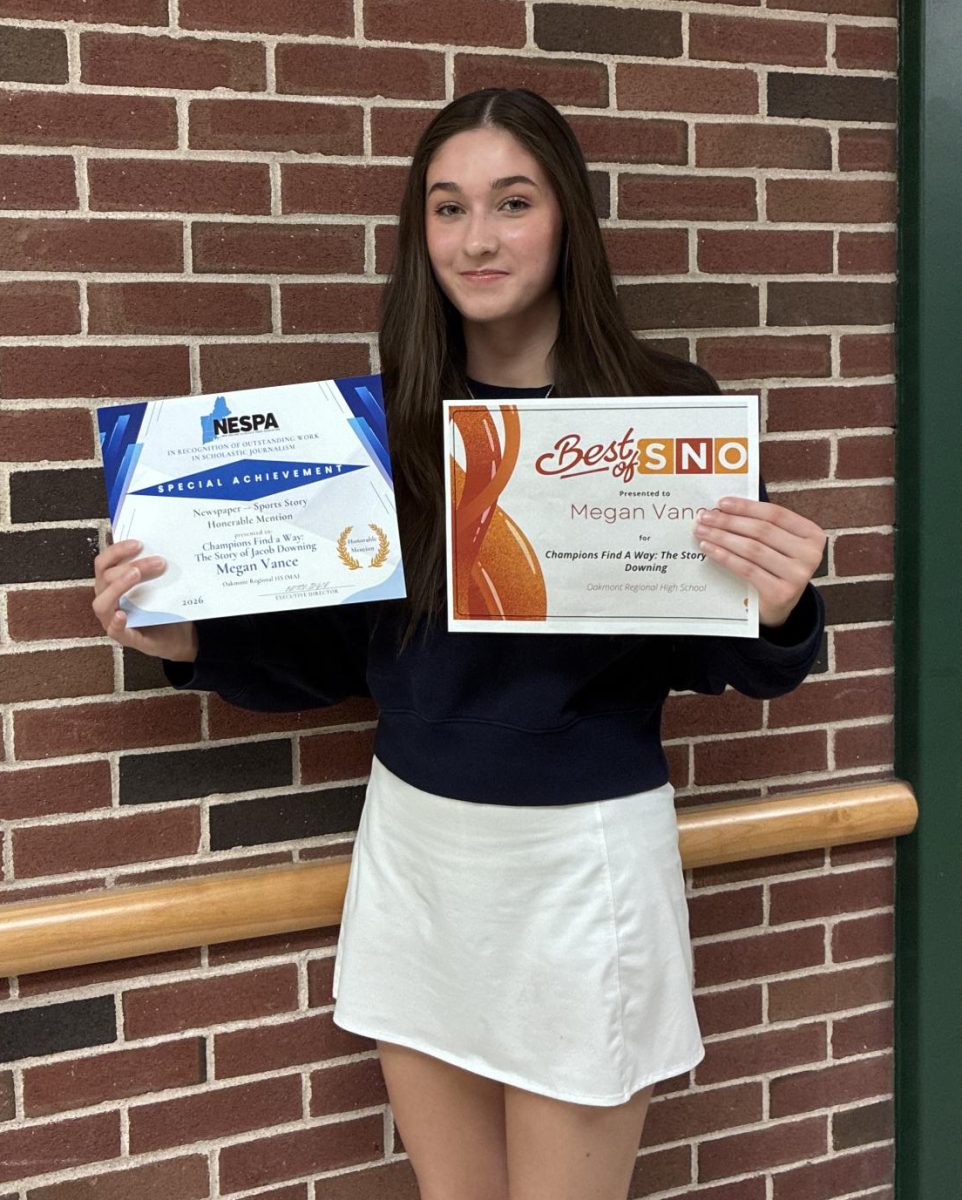 Oakmonitor editor Megan Vance sports her awards for her article Champions Find a Way.   National Best of SNO award and New England NESPA award.