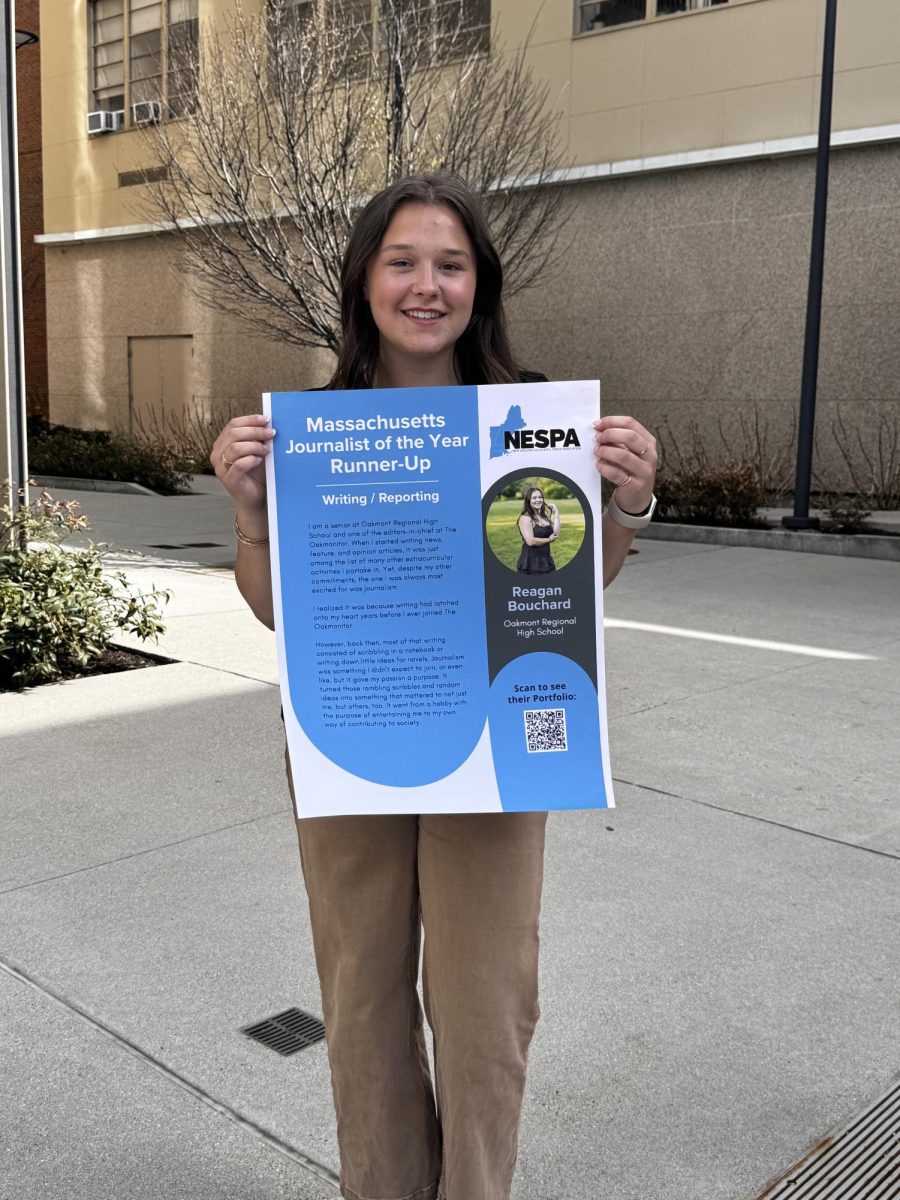 Massachusetts Journalist of the Year Runner-Up Reagan Bouchard shares her placard and smile after being recognized at the NESPA Conference on May 1st. 