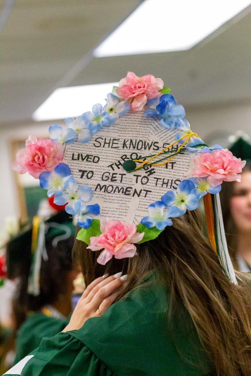 Oakmont Senior Amelia Garlock decorates her graduation cap with a quote that reflects on her growth, memories, and accomplishments through her journey in high school. 